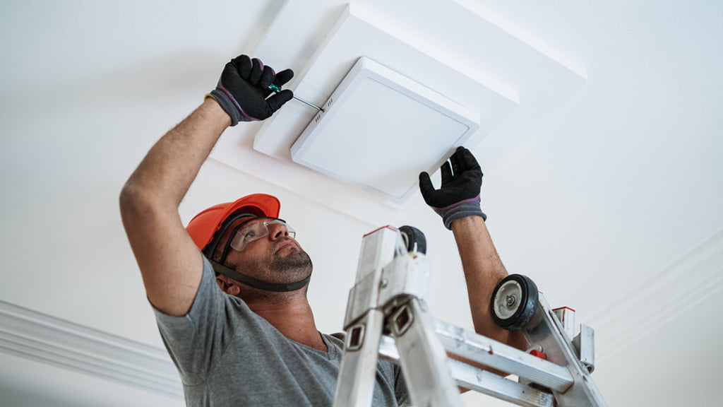 Electrician installing a light fitting
